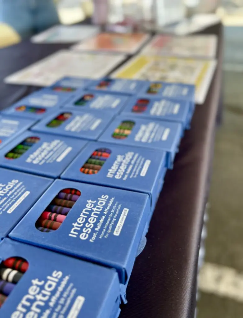 Internet Essentials-branded crayons at a back-to-school event.