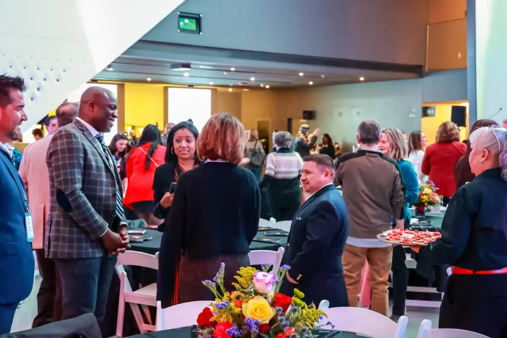 Guests talking at the Comcast RISE Day celebration in Colorado Springs, Colorado.