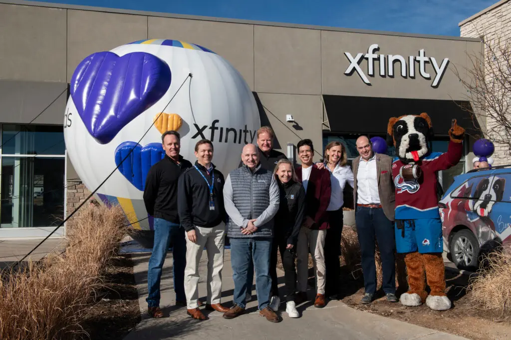 Comcast employees posing outside of the new Xfinity Store in Fort Collins.