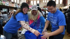 Comcast Cares Day volunteers wrap gifts.
