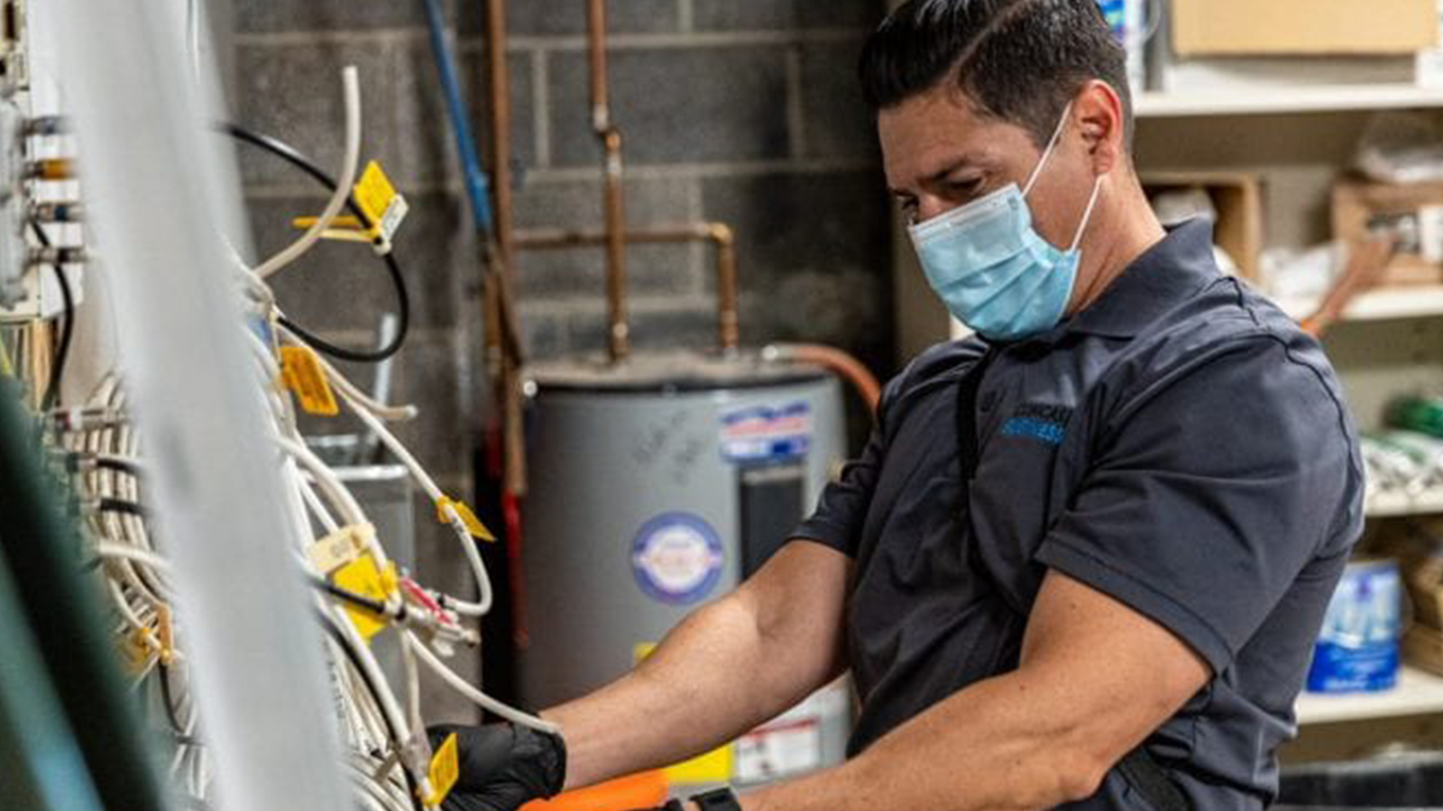 An employee working wearing a mask.