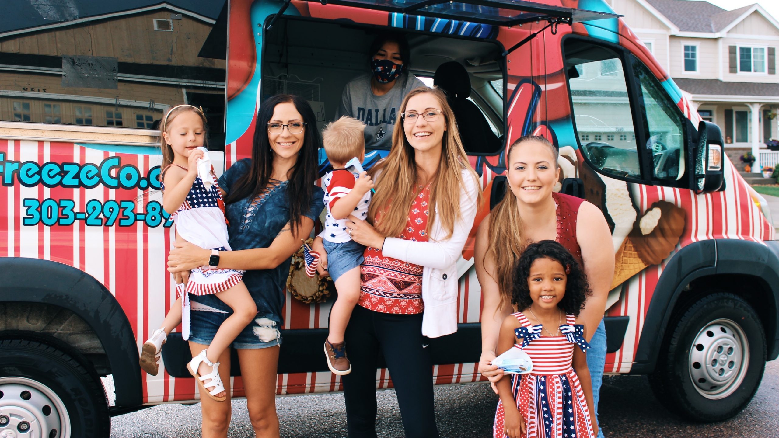 A group of people in front of an ice cream truck