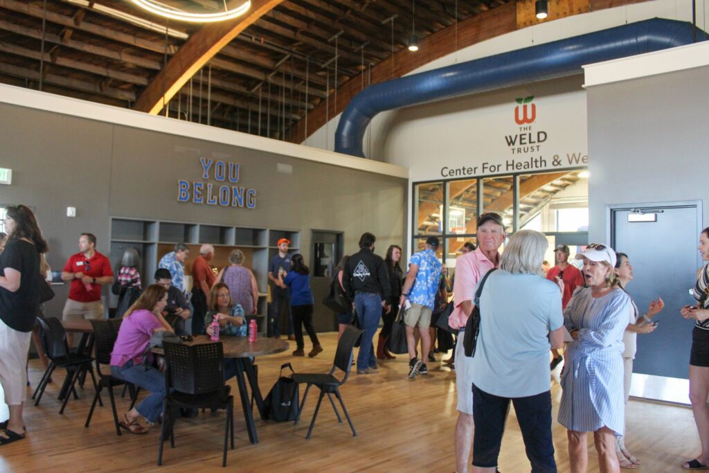 Guests talking at the Boys & Girls Clubs of Weld County's new Teen Center grand opening event.