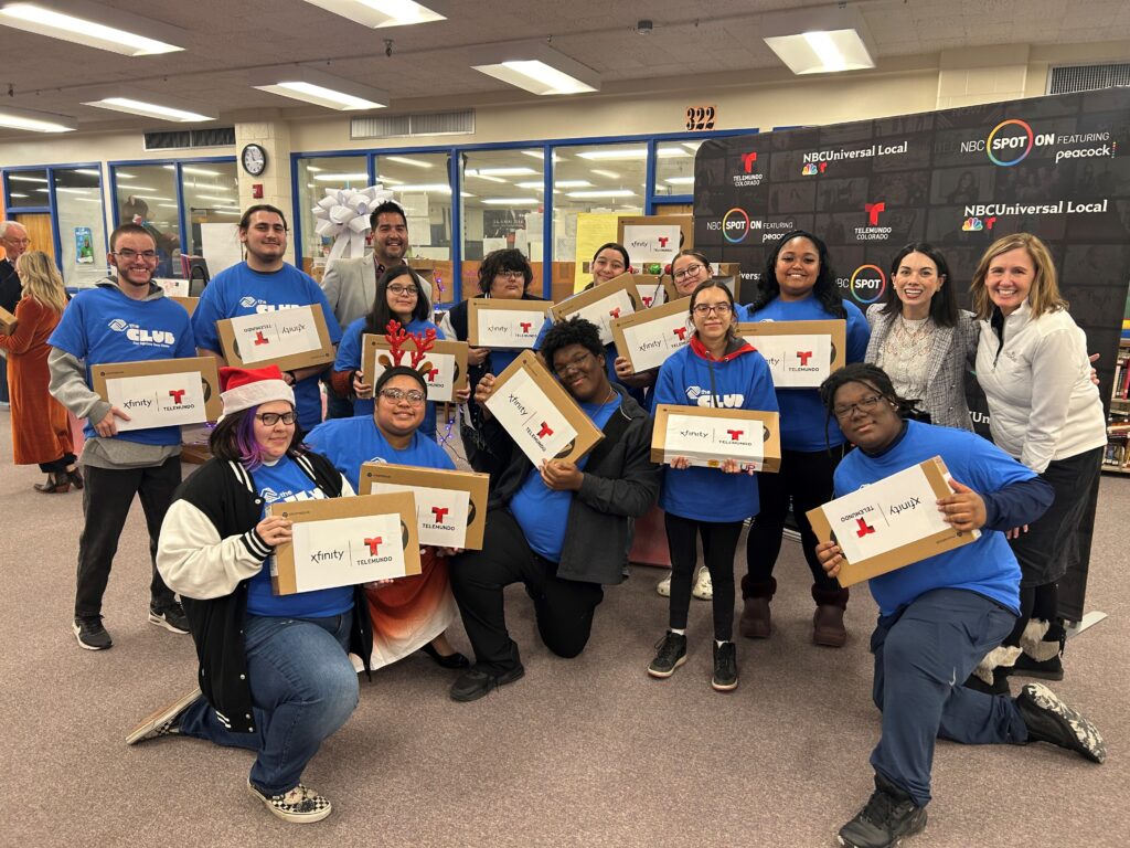 Students posing with laptops at the Boys & Girls Club of Pueblo County holiday event.